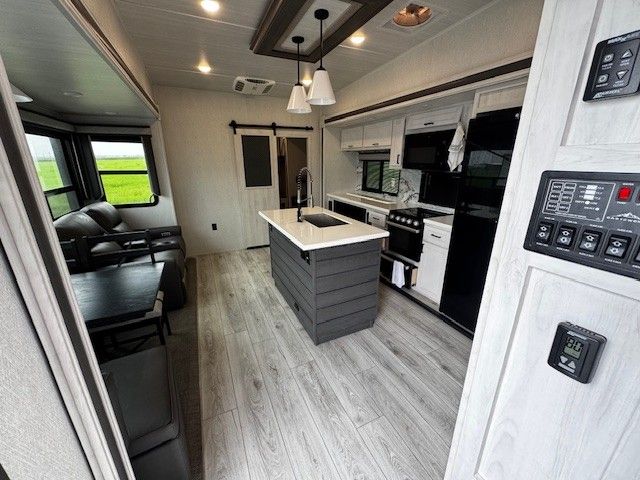 A kitchen with a large island in the middle of it.