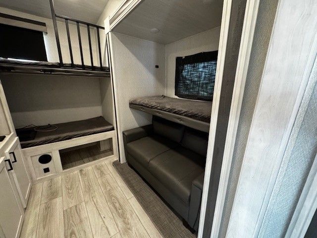 There is a couch and bunk beds in the room.