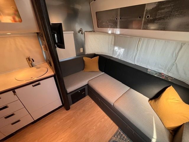 A living room with a couch and a sink