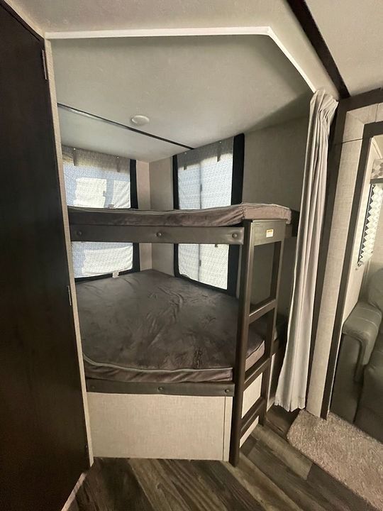 There is a bunk bed in the middle of the room.