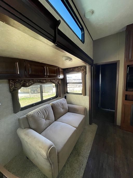 A living room with a couch and a window