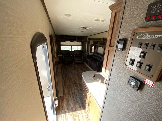 The inside of a rv with a lot of electrical switches on the wall.
