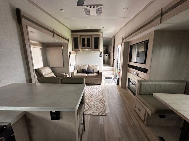 A living room with a couch a table and a fireplace