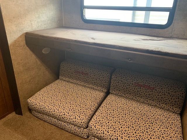 A room with a couch and a window in it