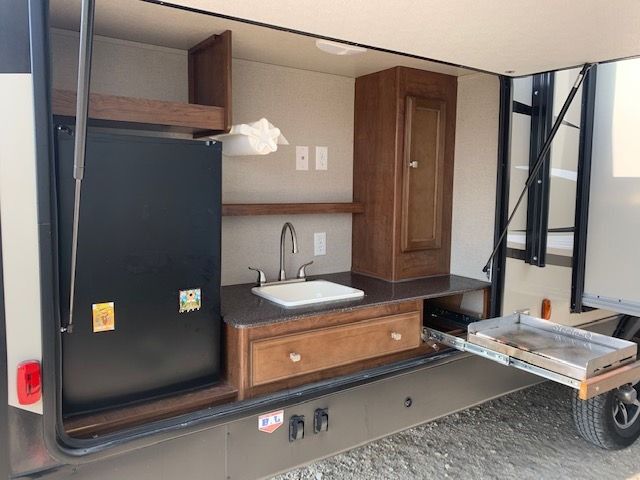 A trailer with a sink and a refrigerator on it