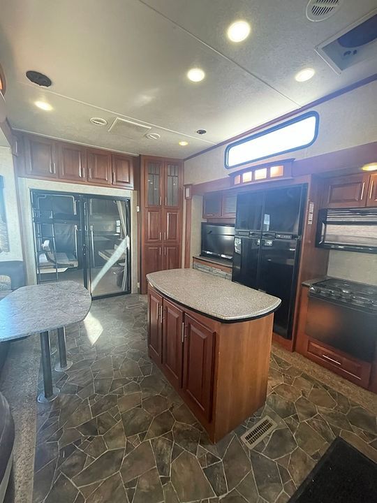 There is a large island in the middle of the kitchen.