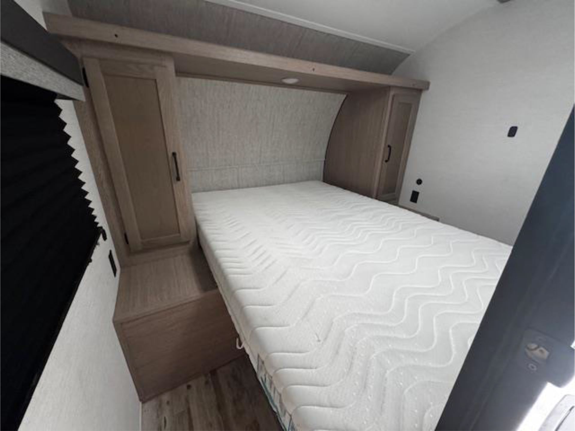 A mattress is sitting on top of a bed in a trailer