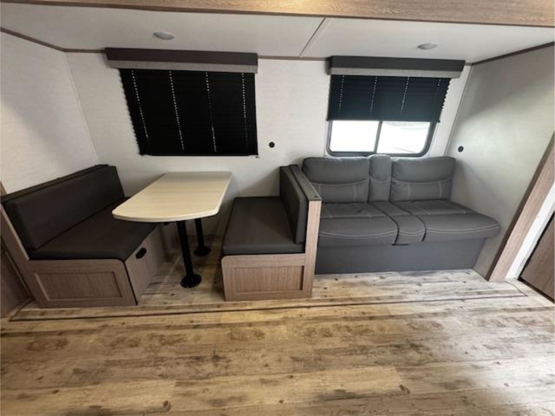 A living room with a couch, table, and benches