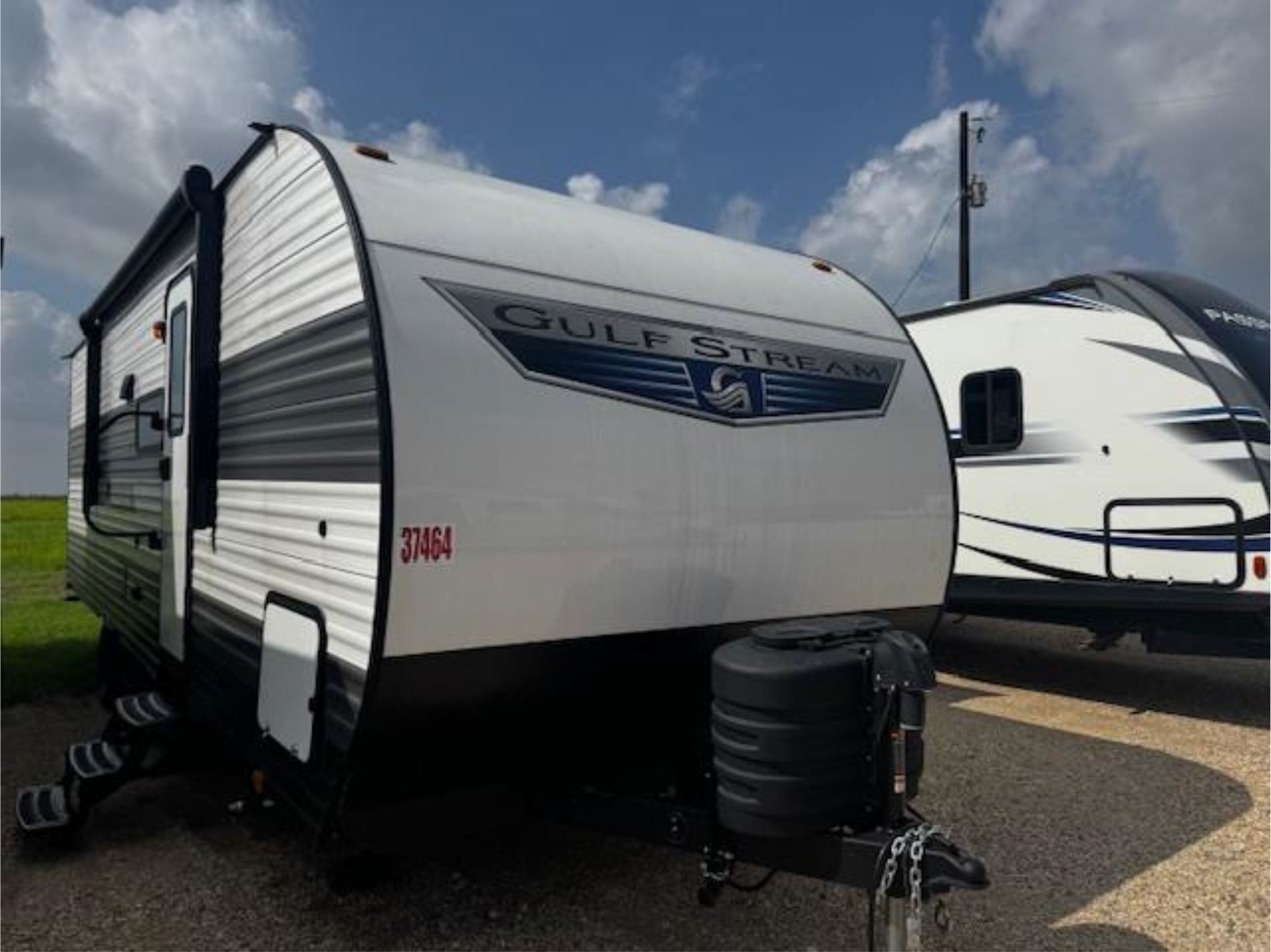 A gulf stream trailer is parked next to another trailer
