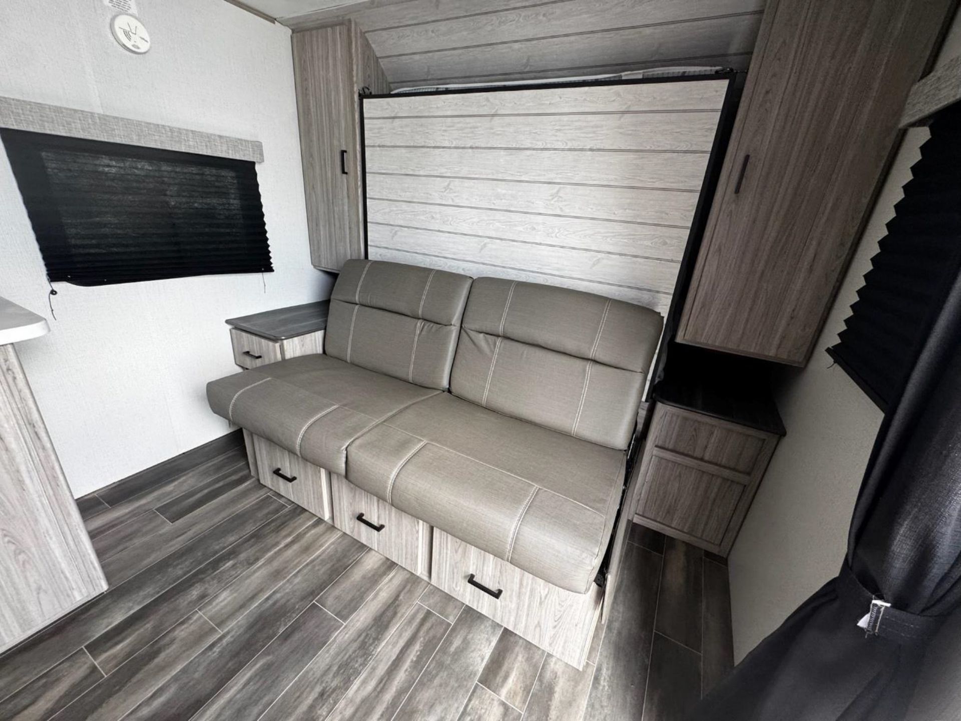 A couch is turned into a bed in a trailer