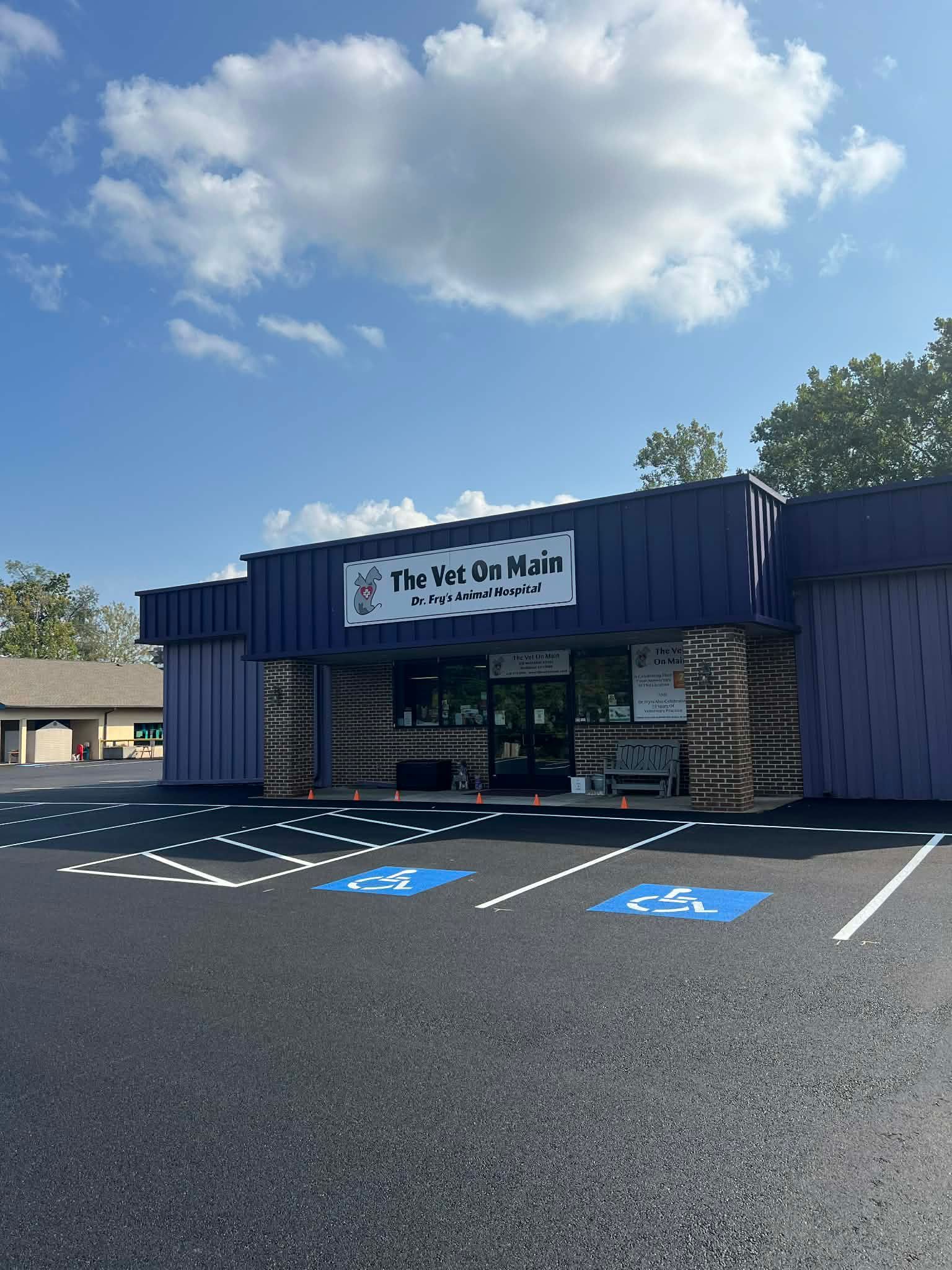 Exterior of Five Valleys Mail, a purple building with accessible parking spaces.