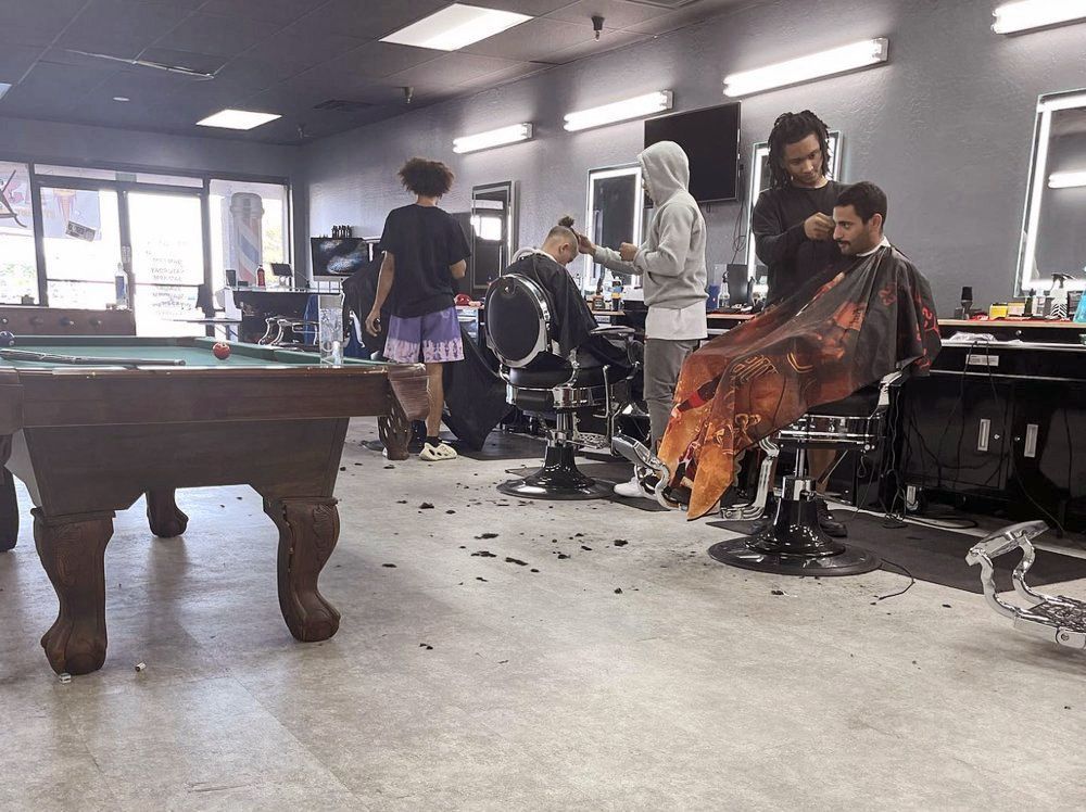 a pool table is in the middle of a barber shop