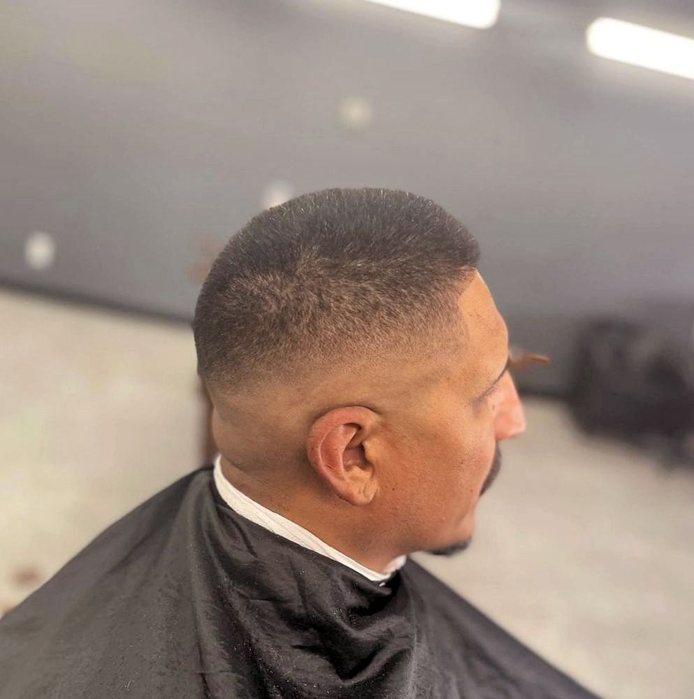 a man is getting his hair cut at a barber shop