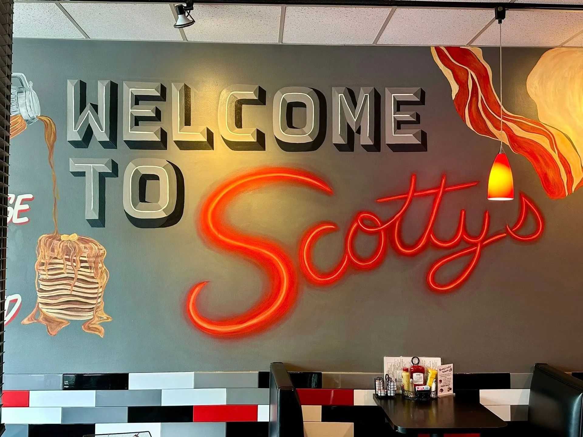 A wall mural inside Scotty's restaurant featuring large 3D letters spelling