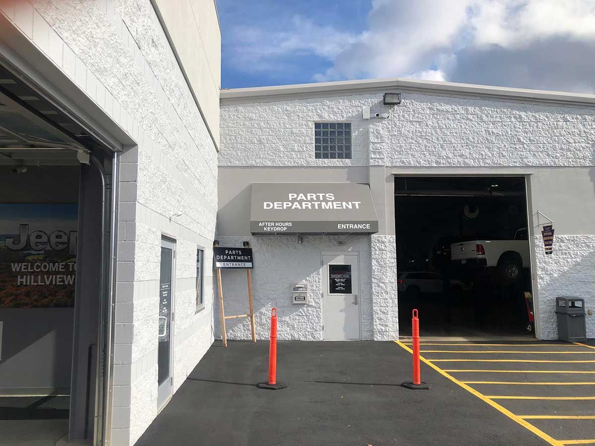 A white building with a sign that says paint department