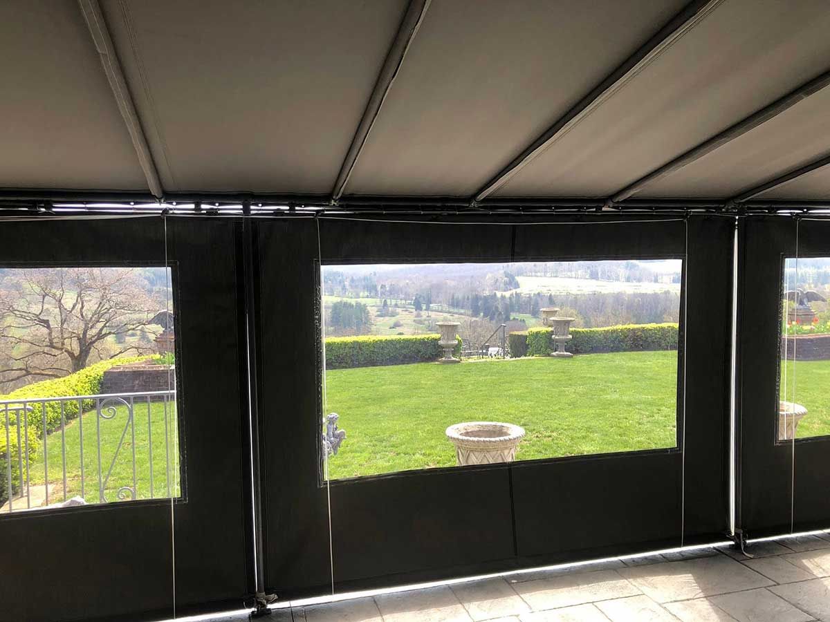 A gazebo with a view of a lush green field.