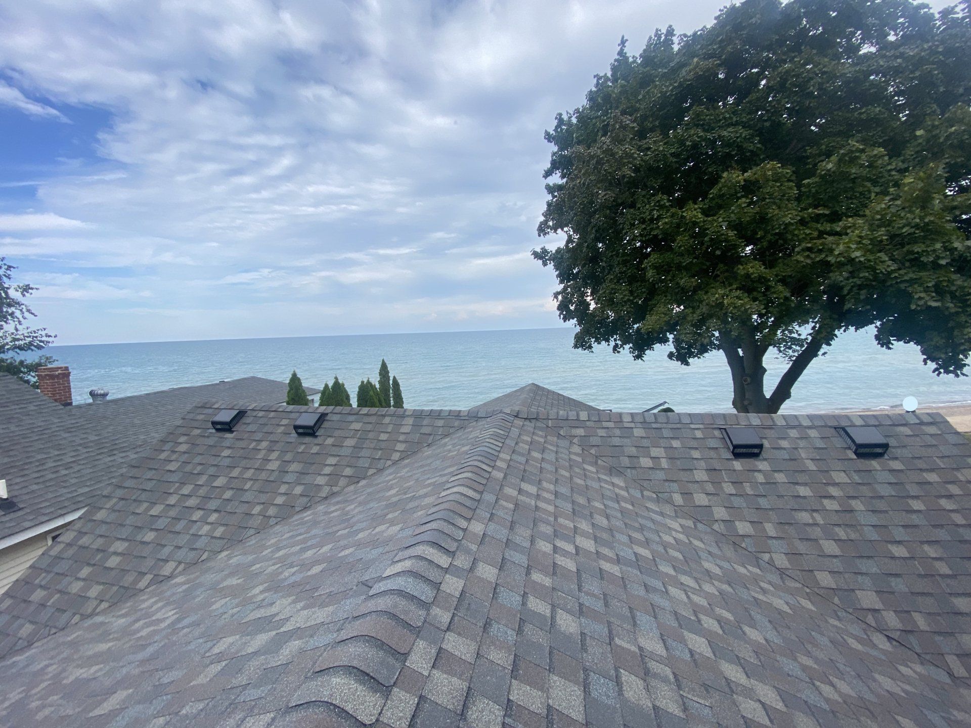 A view of the ocean from the roof of a house