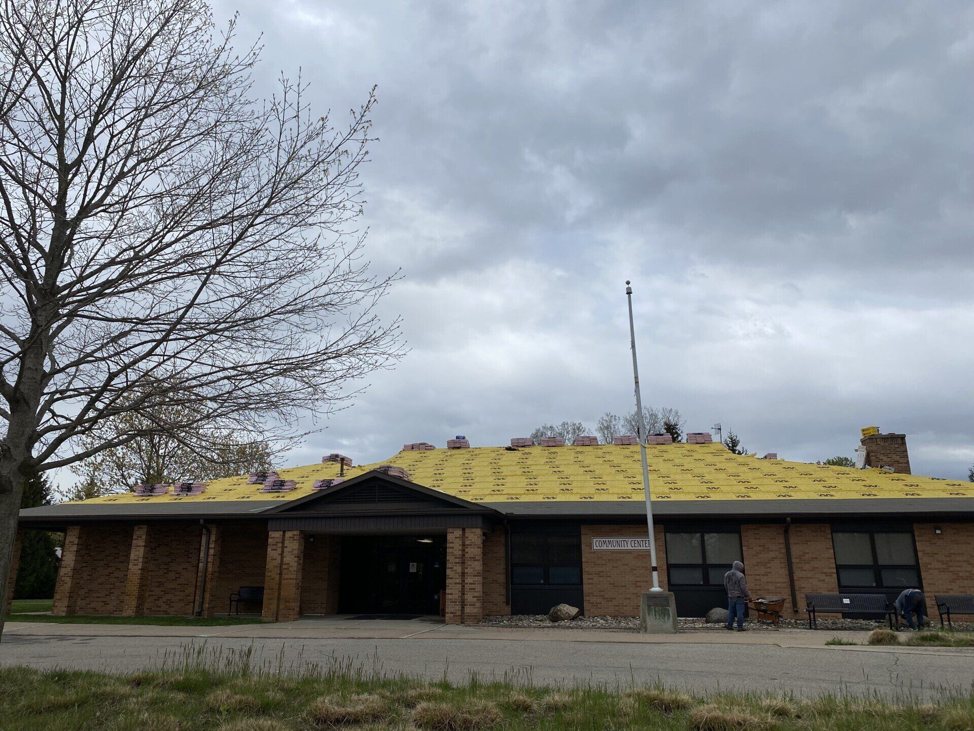 Community center building undergoing a new roof installation