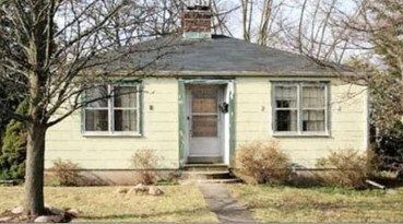 Small pale house with a front door and bare trees, labeled “BEFORE”