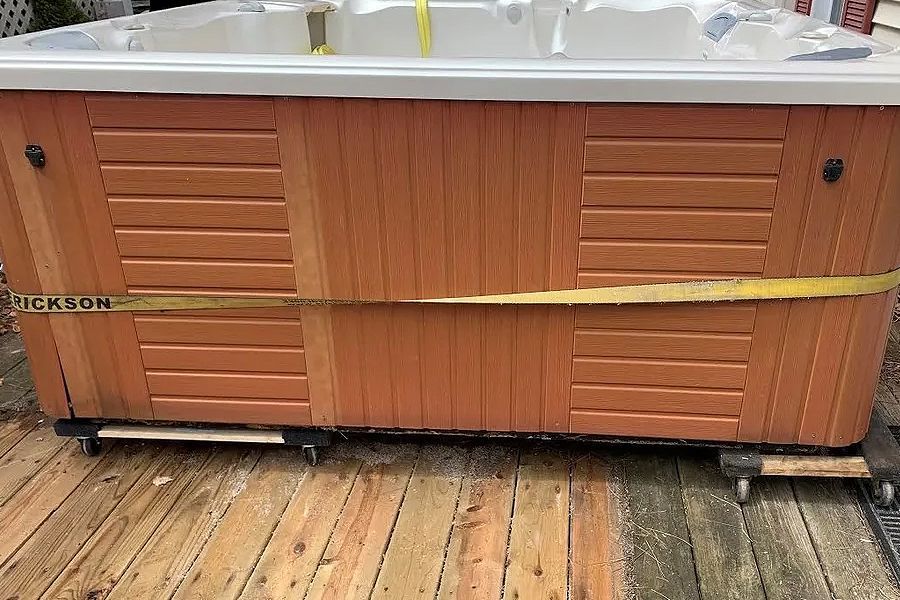Learn More About Hot Tub & Shed Removal A large hot tub is sitting on top of a wooden deck