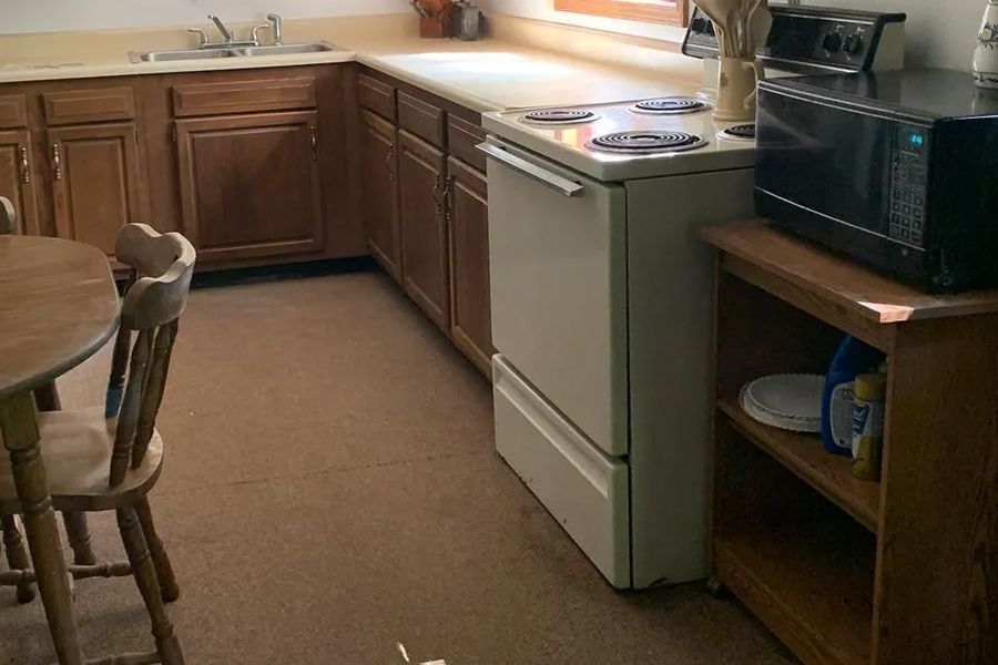 Learn More About Appliance Removal A kitchen with a stove a microwave and a table