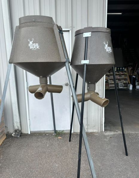 Two buck feeders are sitting in front of a building