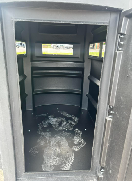 The inside of a black container with the door open.