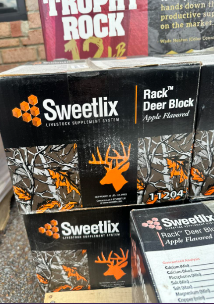 Boxes of sweetlix are stacked on top of each other
