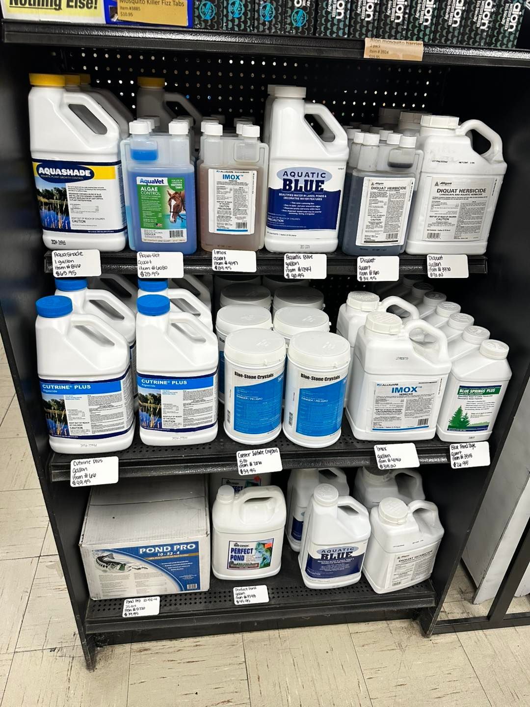 A shelf filled with lots of bottles of chemicals in a store.