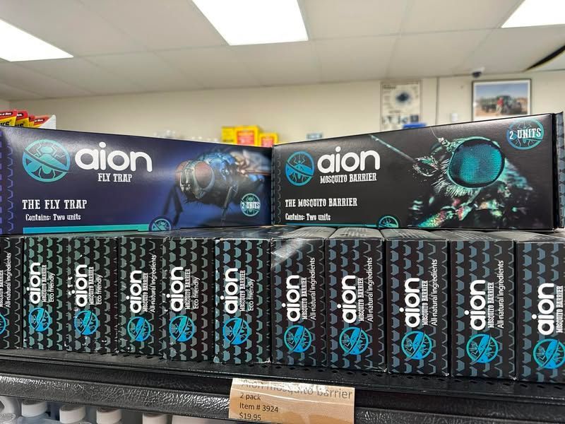 A bunch of boxes of aion fly traps are sitting on a shelf in a store.