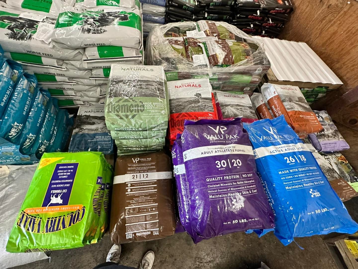 A bunch of bags of fertilizer are stacked on top of each other.