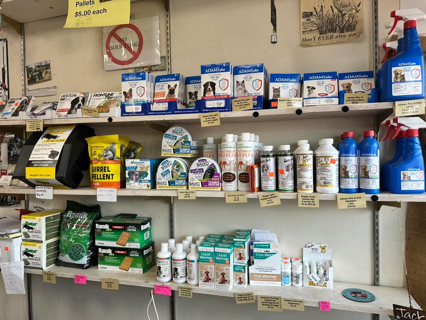 A shelf filled with lots of bottles of chemicals and boxes of food.