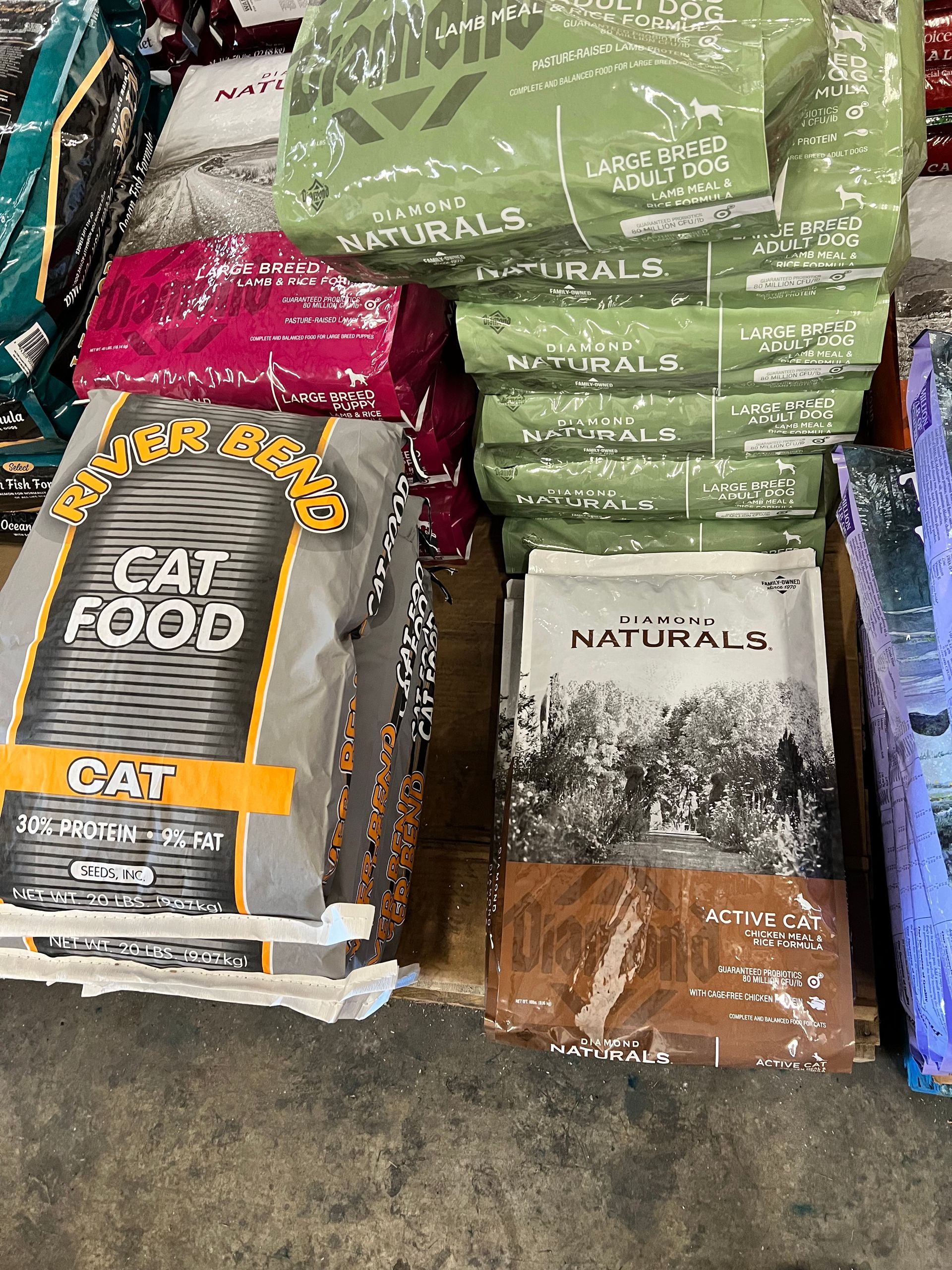 A bunch of bags of cat food are stacked on top of each other