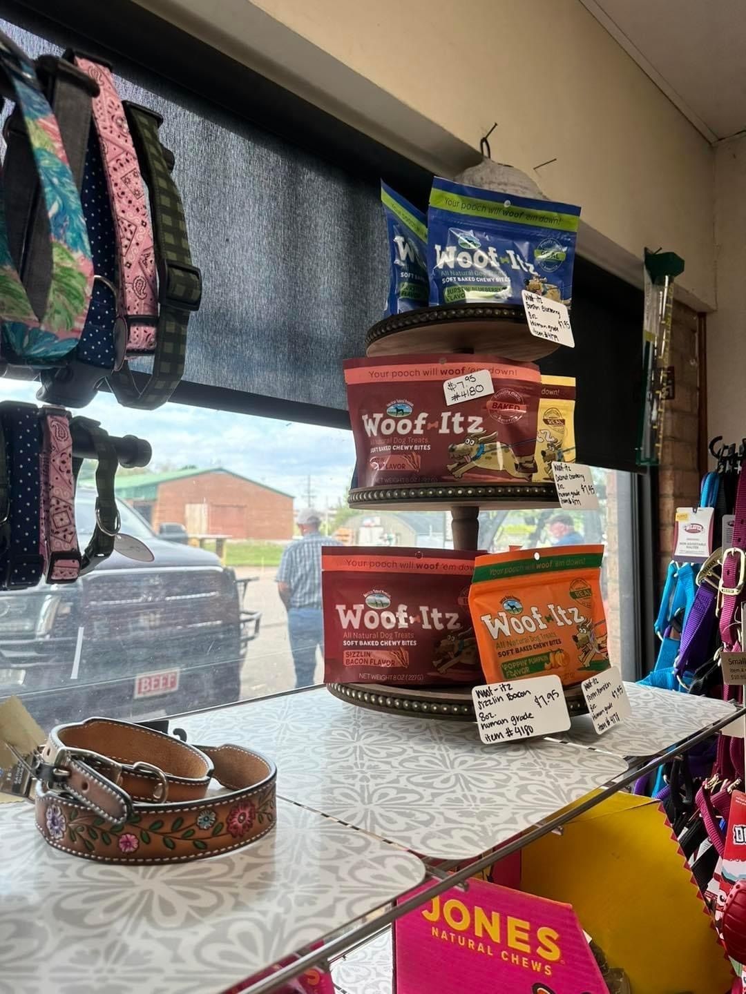 A display of dog treats and collars in a store.