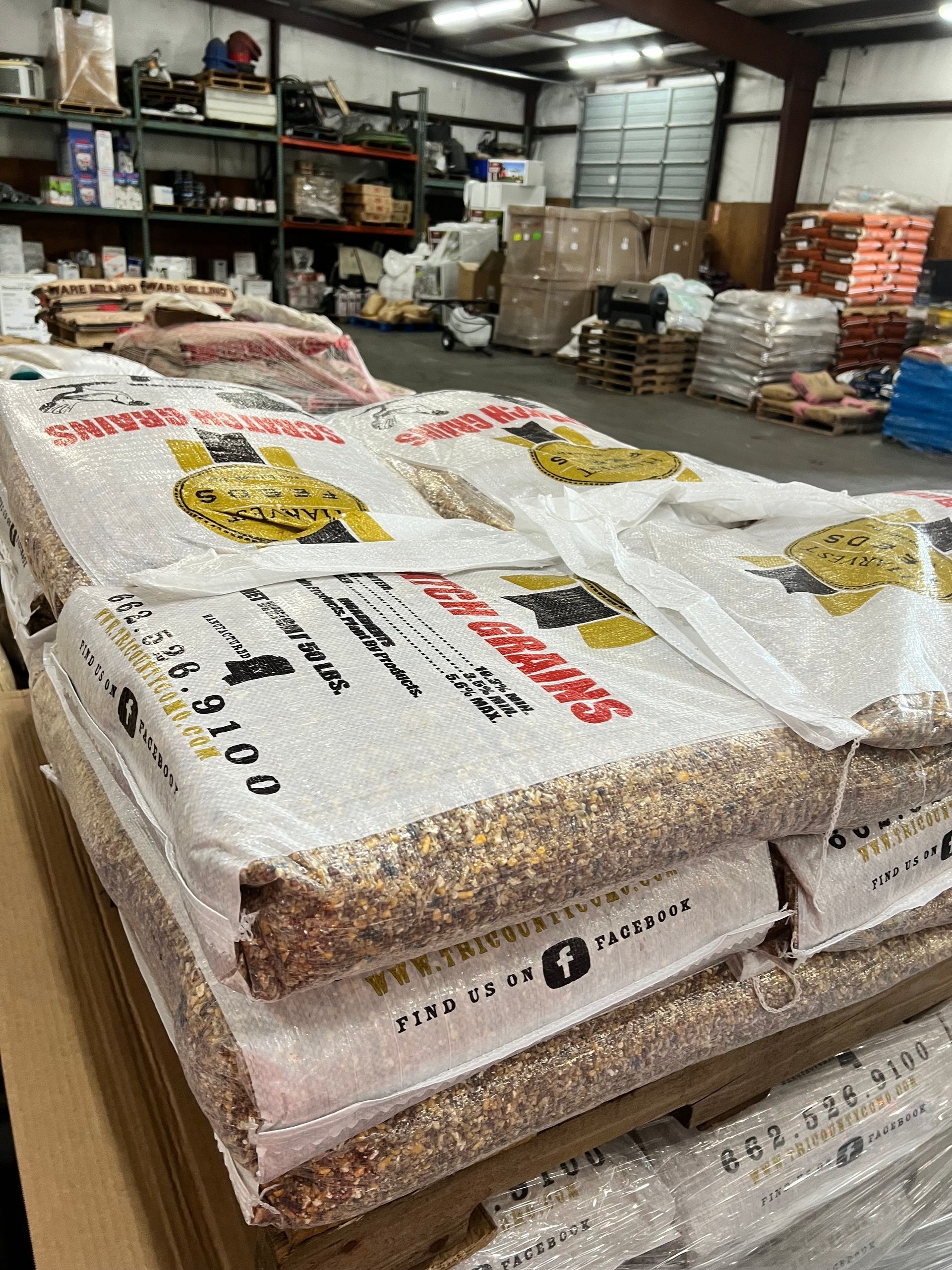 A bunch of bags of corn are stacked on top of each other in a warehouse.