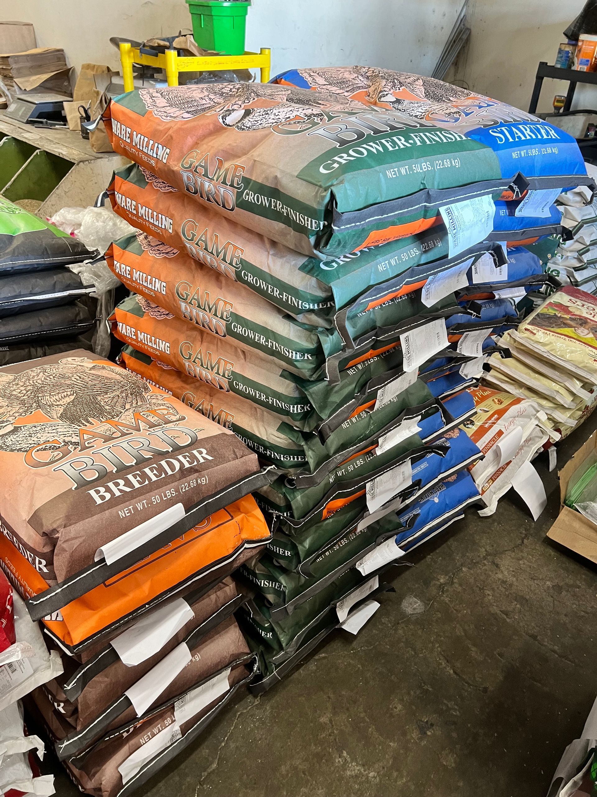 A bunch of bags stacked on top of each other in a store.