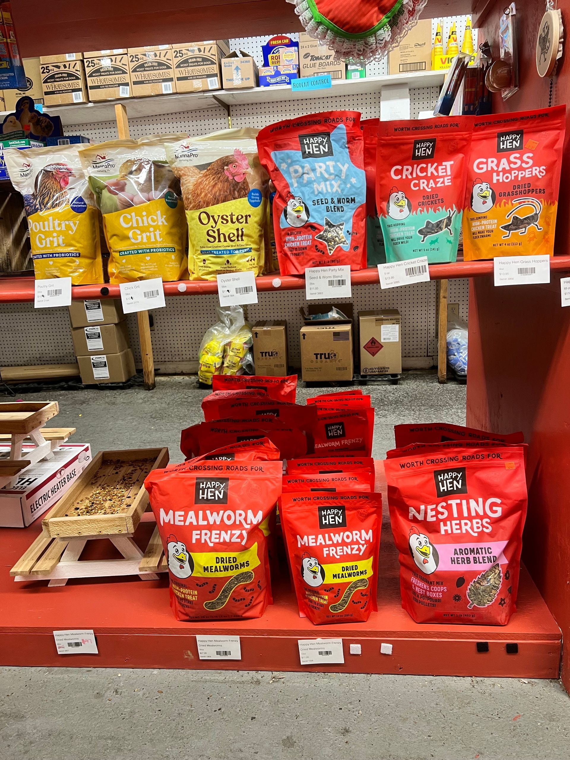 A bunch of bags of food are sitting on a shelf in a store.