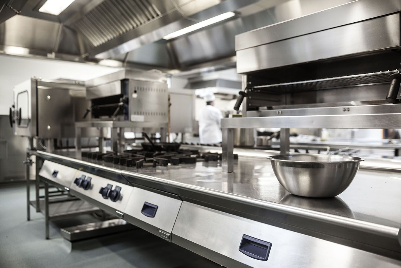 A kitchen with stainless steel appliances and a bowl on the counter.