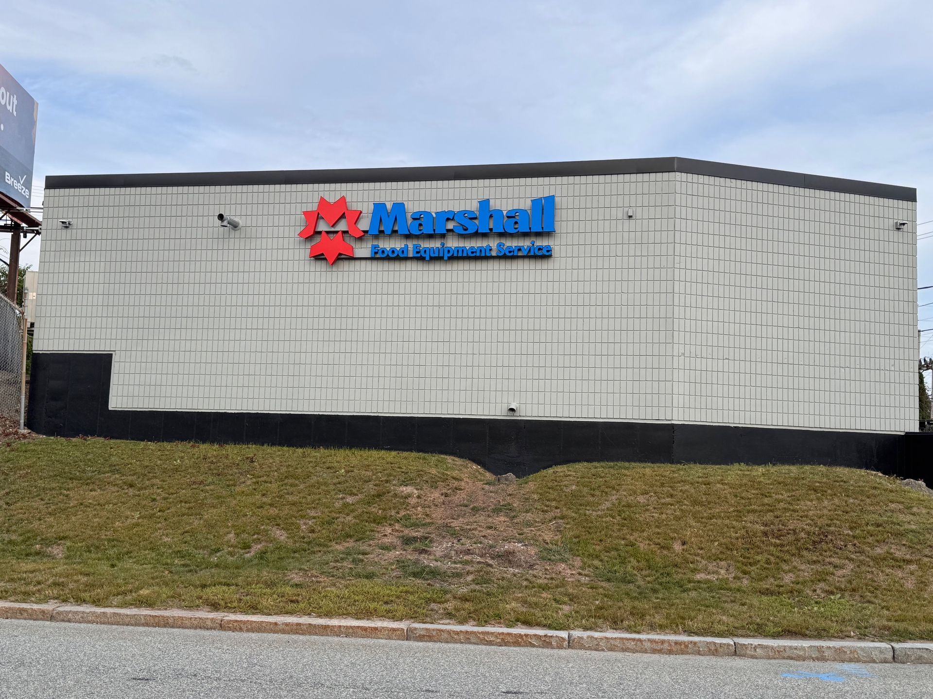 Marshall Pet & Aquarium Supply store with red/blue sign on a light gray building.