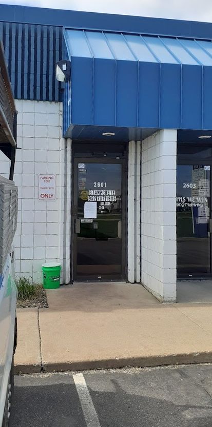 the front of a building with a blue roof and a door