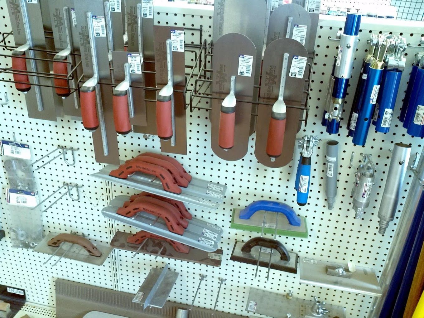 a wall with a bunch of tools hanging on it