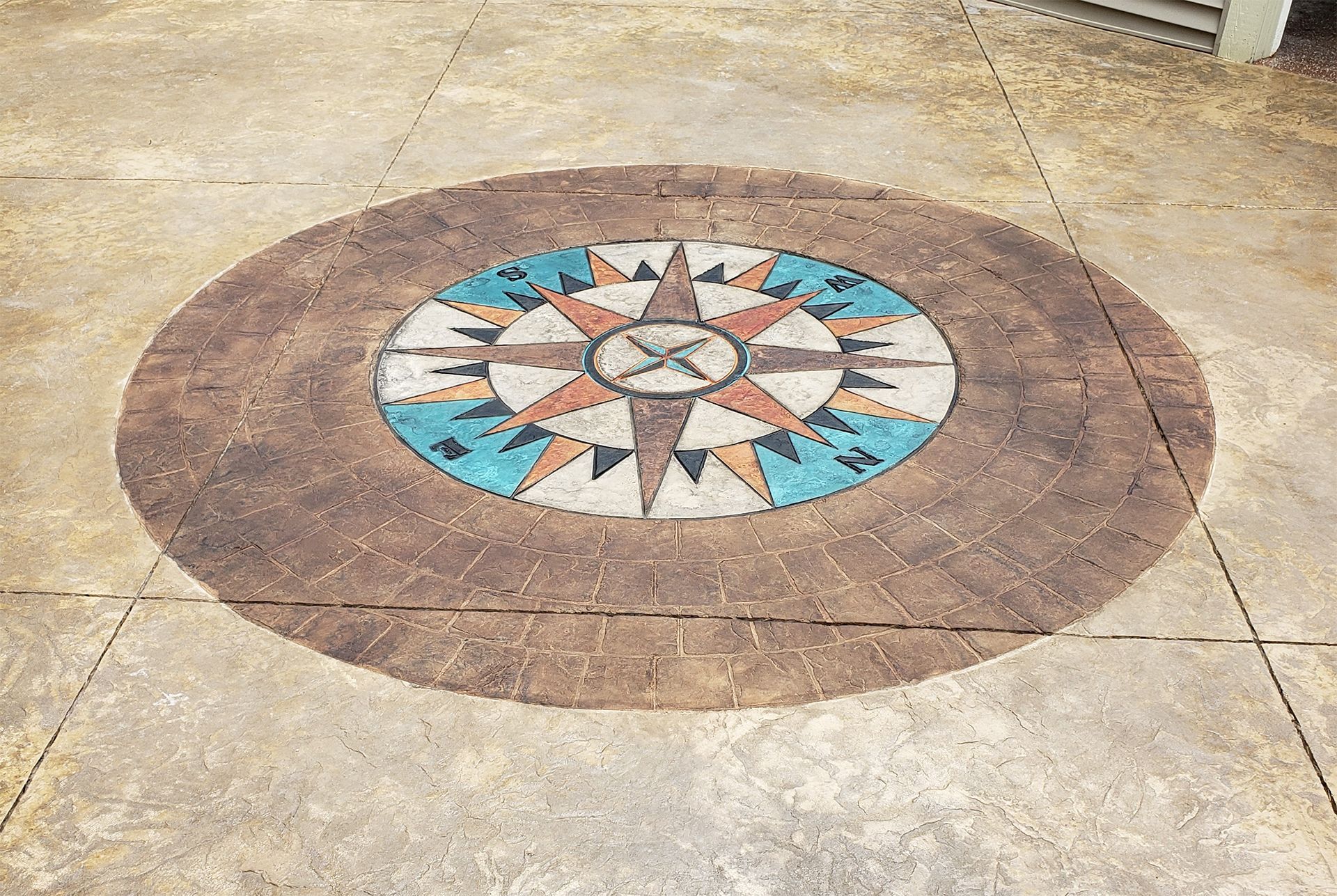 A compass rose in a circle on a concrete floor.
