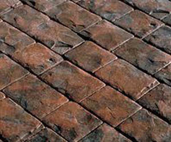 A close up of a brick floor with a diagonal pattern.