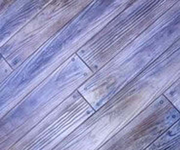 A close up of a wooden floor with a diagonal pattern.