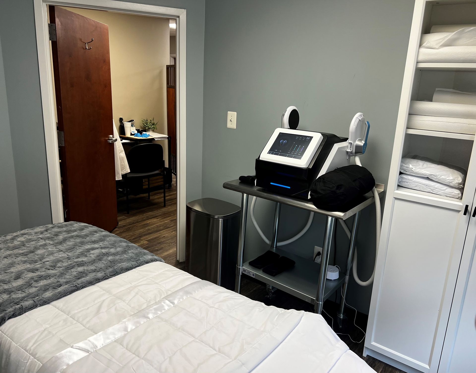 A room with a bed and a machine on a table