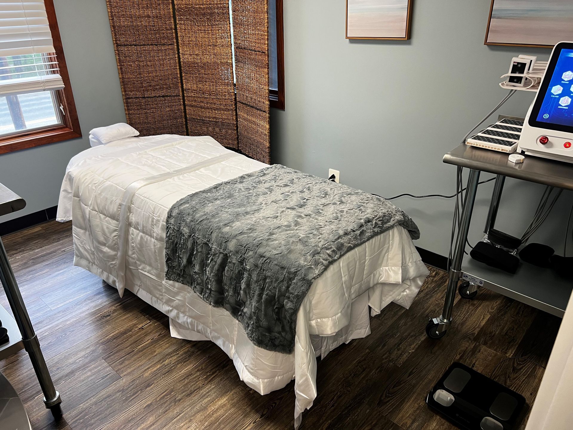 A massage table with a blanket on it in a room