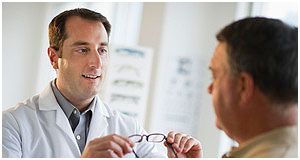 Doctor giving an eye prescription his patient