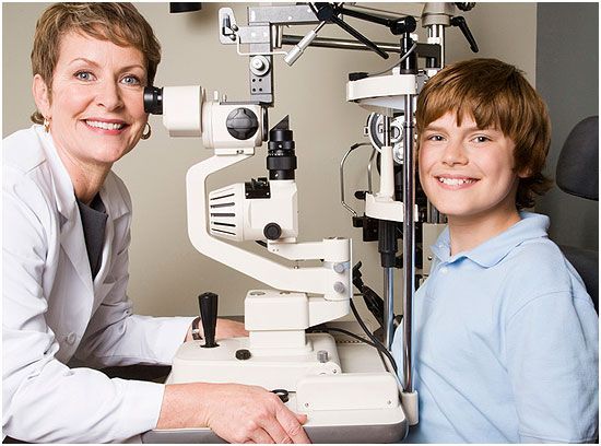 Doctor having a eye check up with a boy
