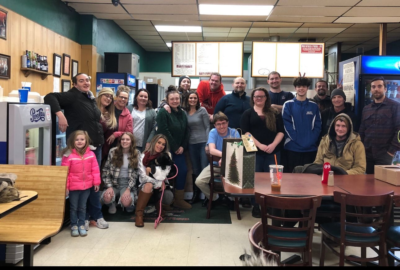 A group of people are posing for a picture in a restaurant.