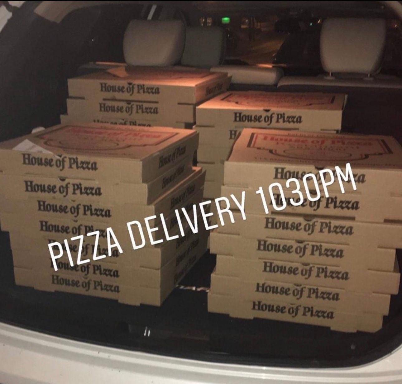 A stack of house of pizza boxes in the back of a car